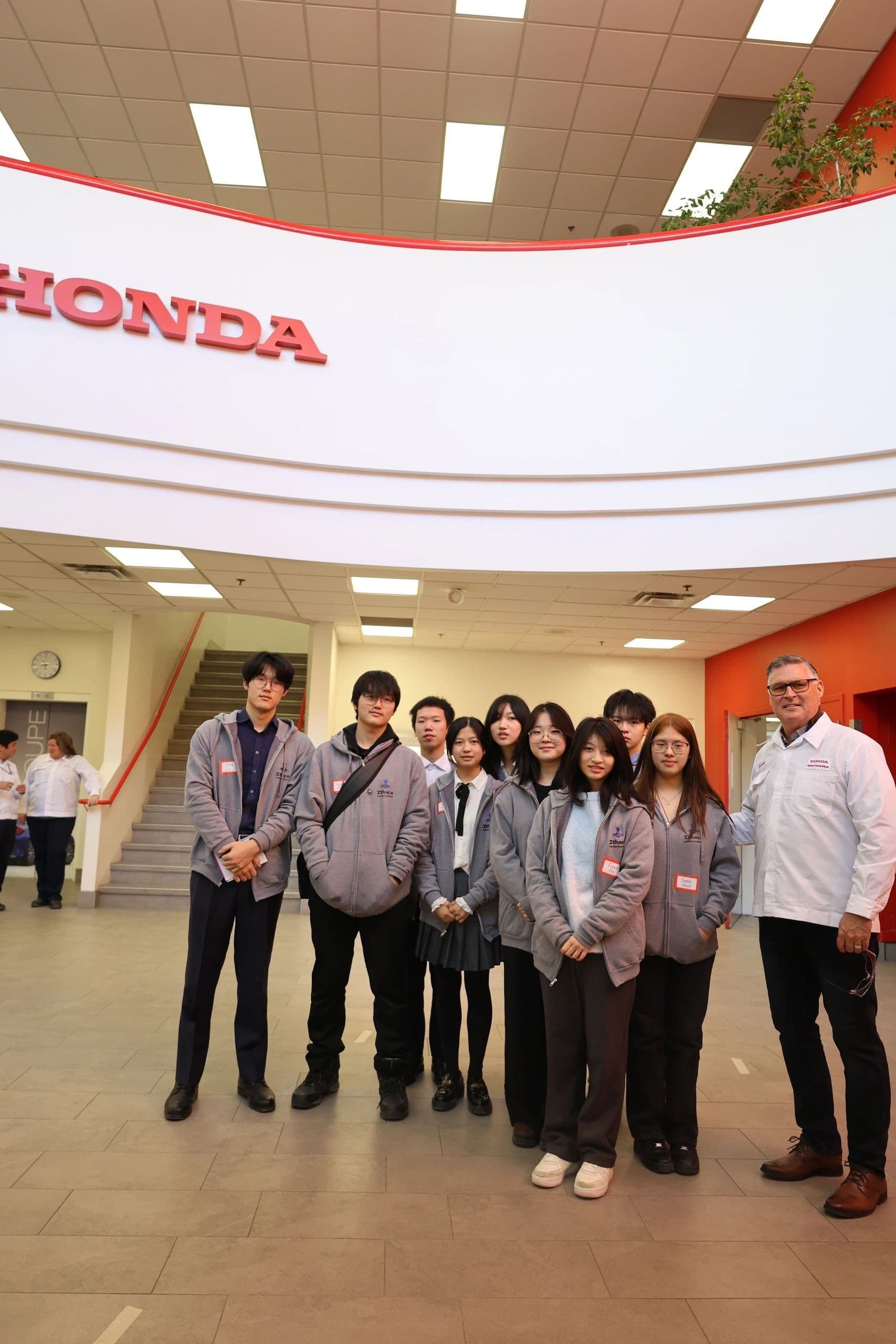 Students visiting Honda electric vehicle production line