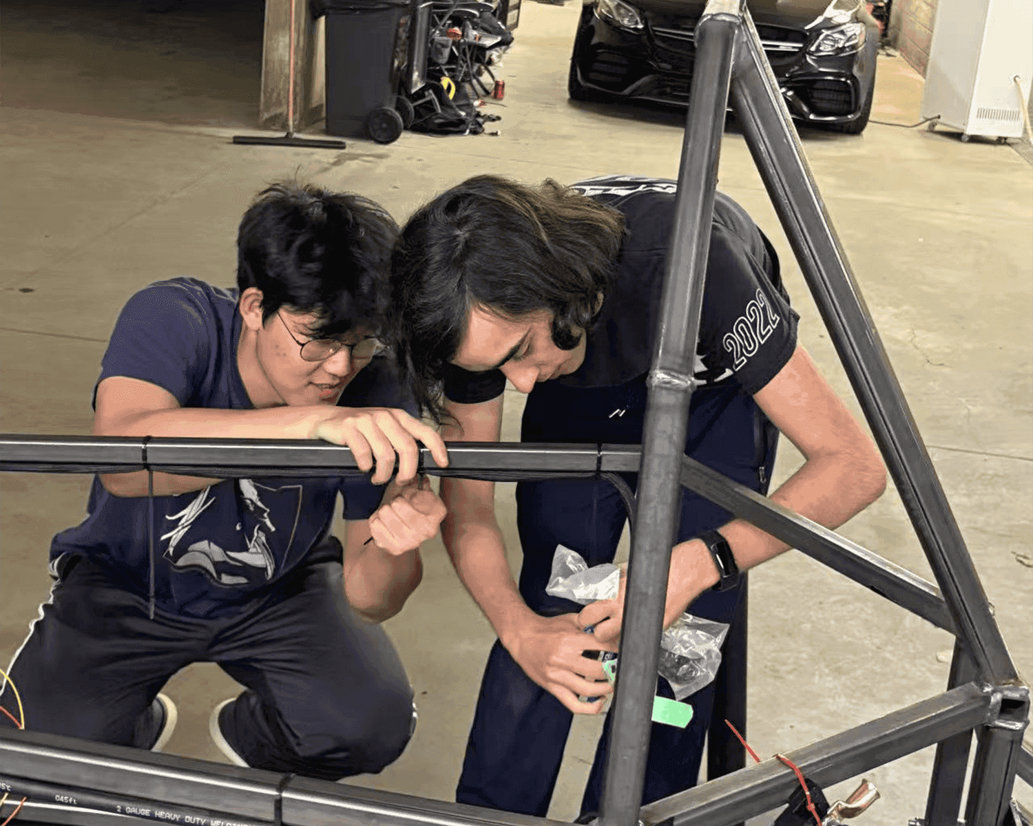 Students working on electric vehicle components during workshop